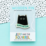 Black cat wooden pin badge that reads Black Cat Club