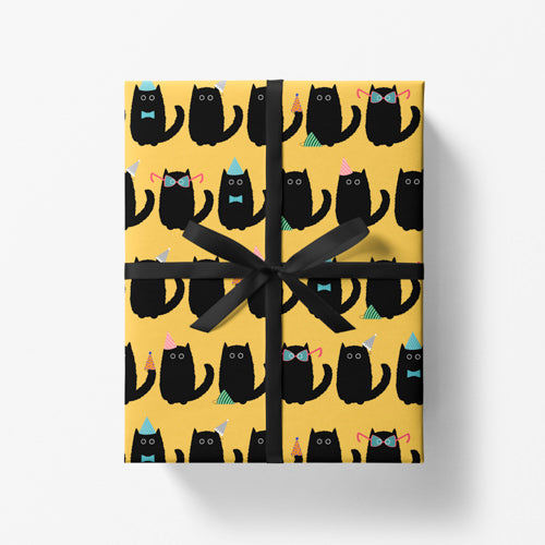 Yellow gift wrap with a black cat pattern