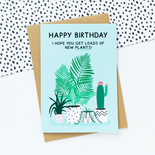 Green birthday card featuring houseplants in black and white plant pots
